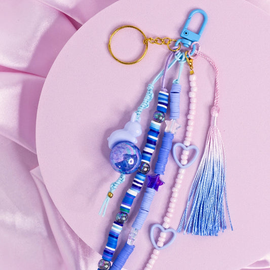 Blue and purple bunny charm keychain with galaxy bead, heart accents, and ombré tassel.