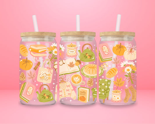 glass tumbler decorated with pumpkins, bread, fall leaves, books, tote bags, and tea, with bamboo lid and straw.
