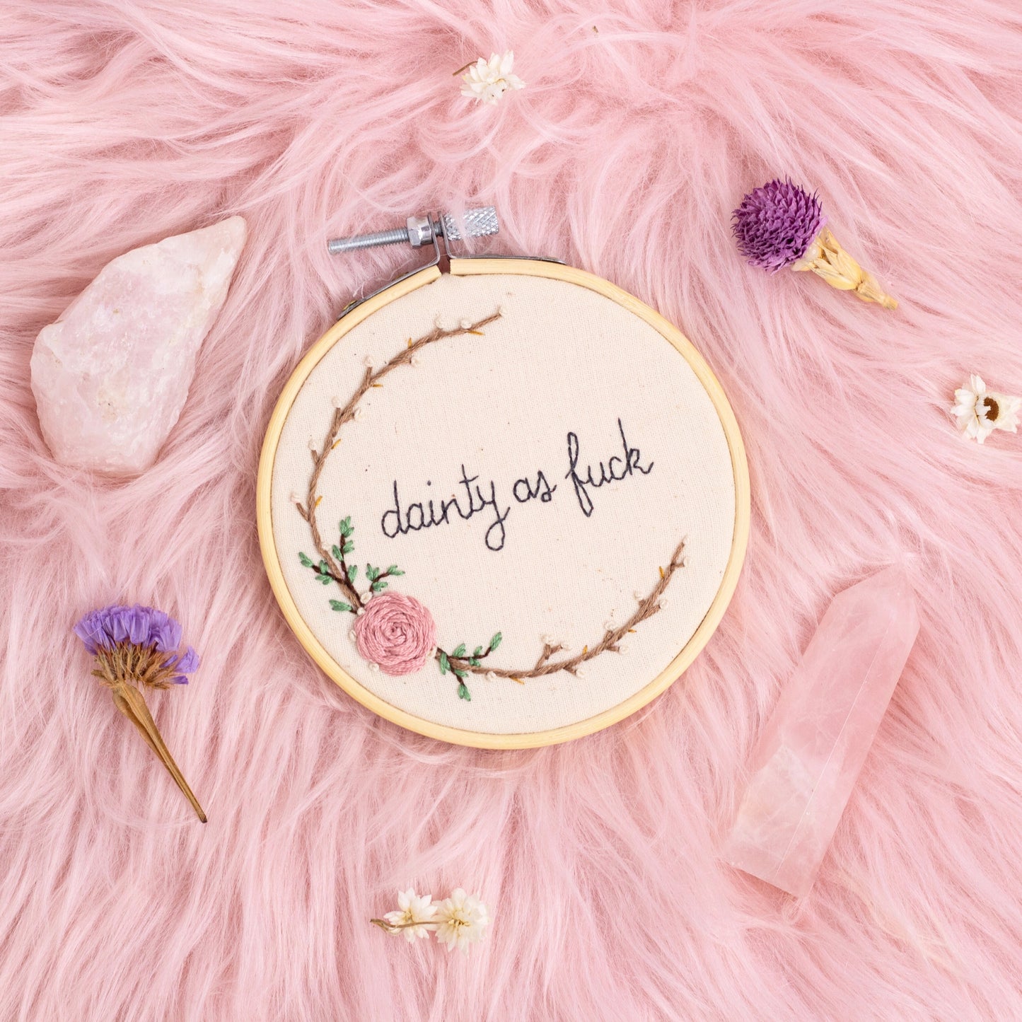 close up of dainty as fuck embroidered quote with floral embroidery in wooden hoop