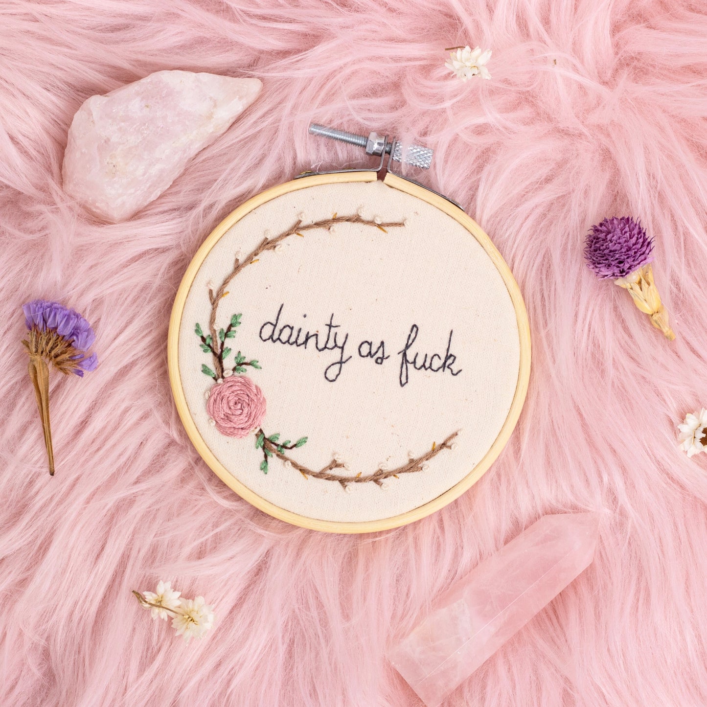 hand embroidered feminist quote hoop with floral wreath on pink background