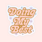 Retro style sticker with pink and gold text that says Doing My Best, surrounded by sparkles and stars.