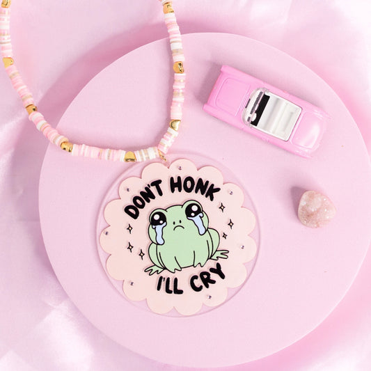 “Kawaii frog car charm with crying face and ‘Don’t honk I’ll cry’ quote – adorable and relatable.”