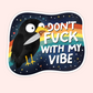 Black crow holding a knife in its beak in front of a rainbow night sky with the phrase “Don’t fuck with my vibe.”