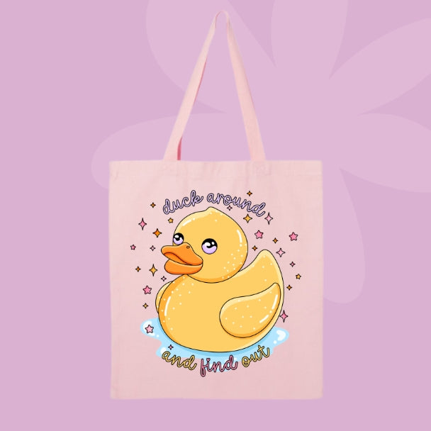 Pink canvas tote bag featuring a cute yellow rubber duck with sparkles and text that says duck around and find out.