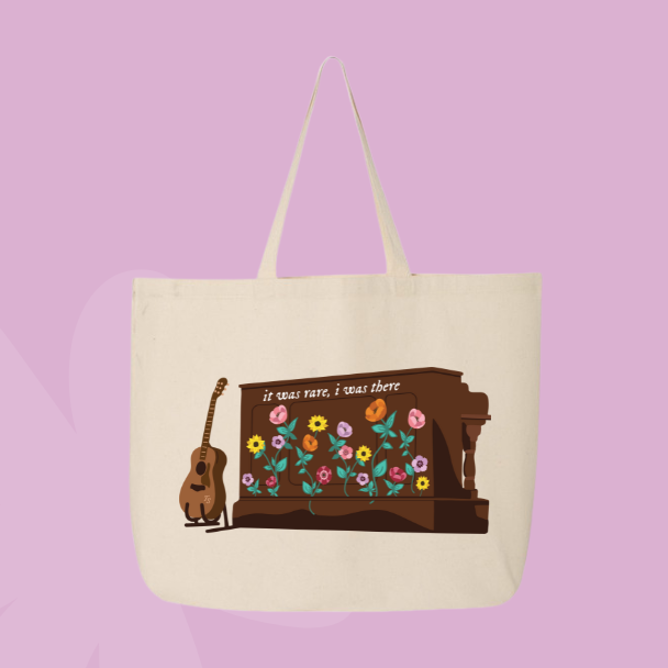 Music inspired tote bag with illustrated piano, flowers, and text reading it was rare I was there, inspired by the Eras Tour acoustic set piano.