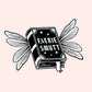 Black and white sticker of a book with fairy wings and the words “Faerie Smutt” on the cover.
