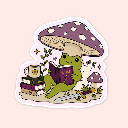 Cute frog sticker reading a fantasy book under a purple mushroom with books, a sword, teacup, pillow, stars, and leafy details.