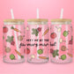 Glass cup with pink background decorated with hand-drawn vegetables like tomatoes, carrots, onions, and text that reads “meet me at the farmers market.”