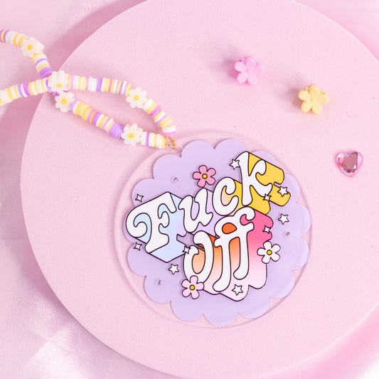 “Pastel purple and yellow ‘F*ck Off’ car charm with bold retro font and floral accents – sassy and unapologetic.”