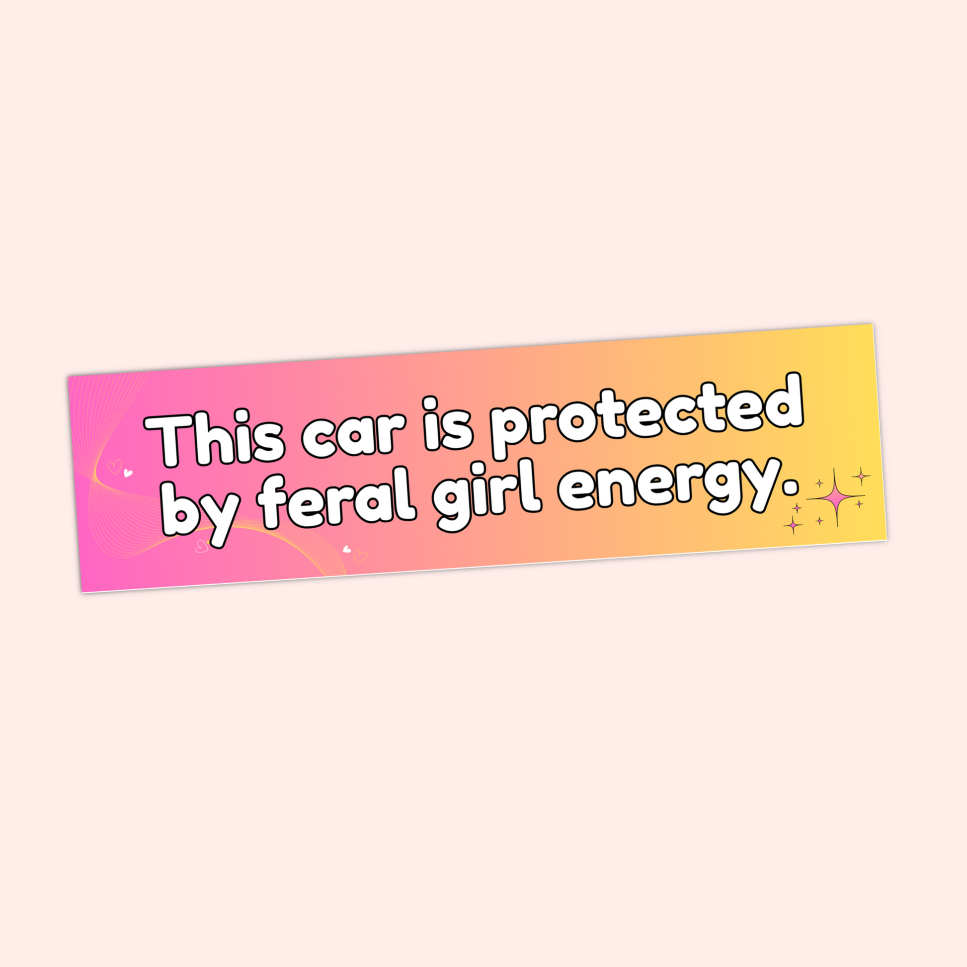 A hand holding a gradient pink-to-yellow bumper sticker with the text "This car is protected by feral girl energy" and sparkles.
