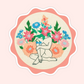 Sticker of original embroidery art featuring a seated body outline surrounded by colourful embroidered flowers.