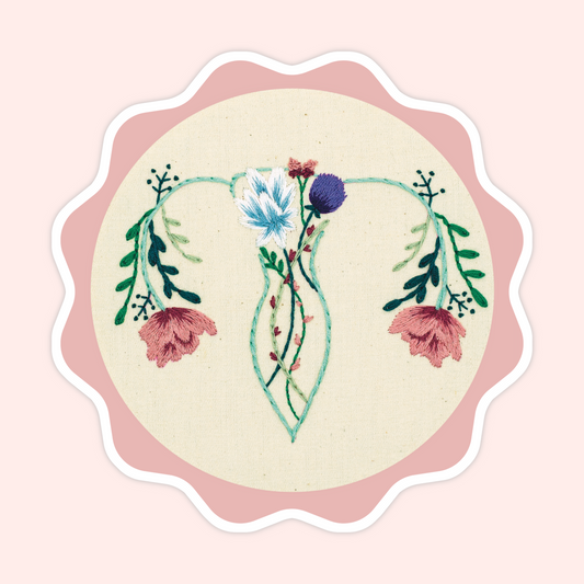 Sticker of original embroidery art featuring a uterus-inspired floral design with teal vines, pink flowers, and botanical details.