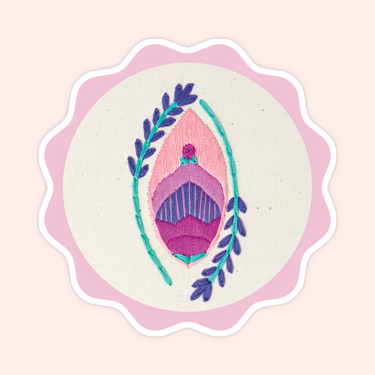 Sticker of original embroidery art featuring a floral yoni-inspired design with pink, purple, teal, and botanical details.