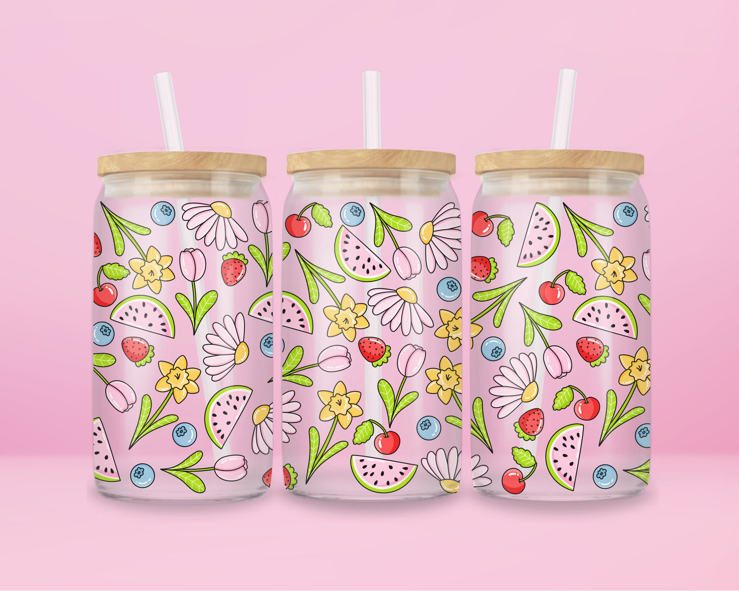 Glass cup with pink background covered in colorful fruits (watermelon, strawberries, blueberries, cherries) and spring flowers (daisies, tulips, daffodils).