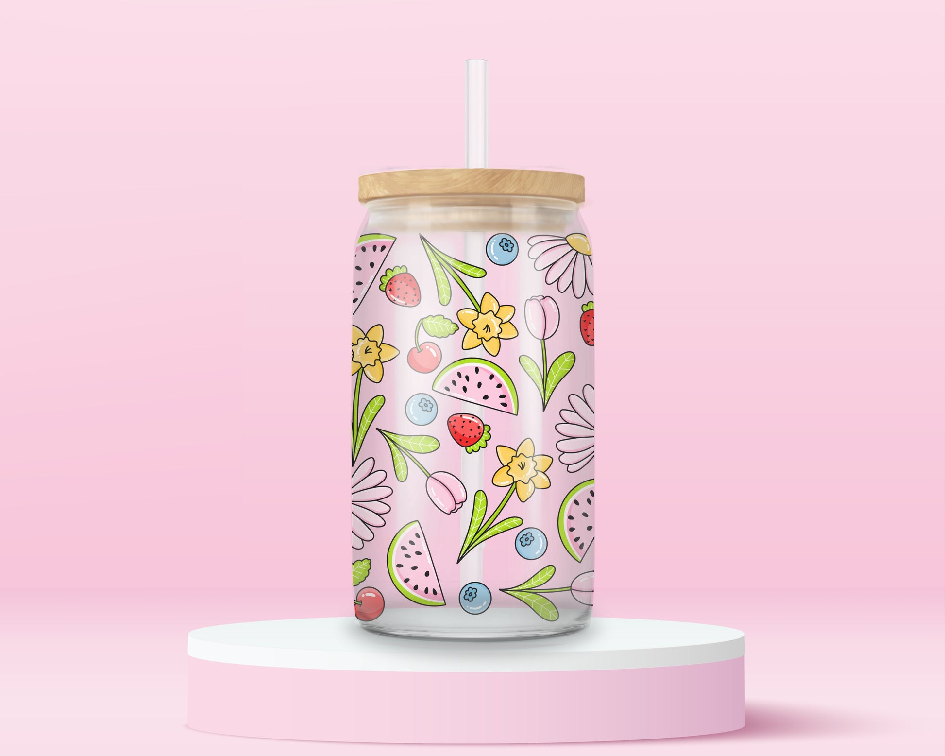 Glass cup with pink background covered in colorful fruits (watermelon, strawberries, blueberries, cherries) and spring flowers (daisies, tulips, daffodils).