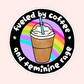 Circular sticker with iced coffee cup and rainbow background that reads “Fueled by coffee and pure feminine rage.”