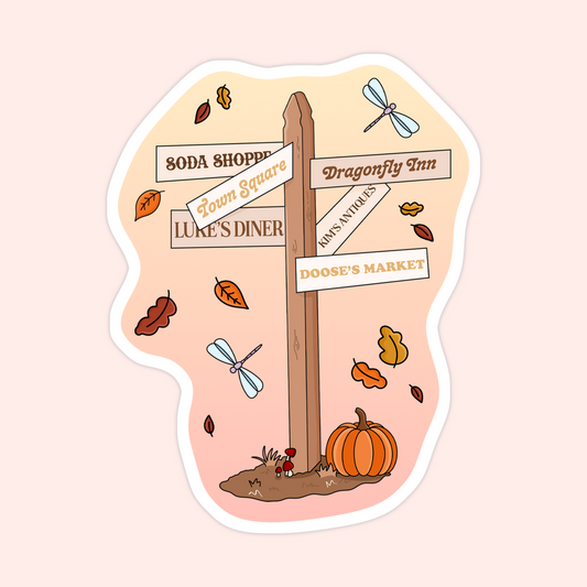 Fall-themed street signpost sticker pointing to Stars Hollow locations like Luke’s Diner, Doose’s Market, and Dragonfly Inn with pumpkins and leaves around it.