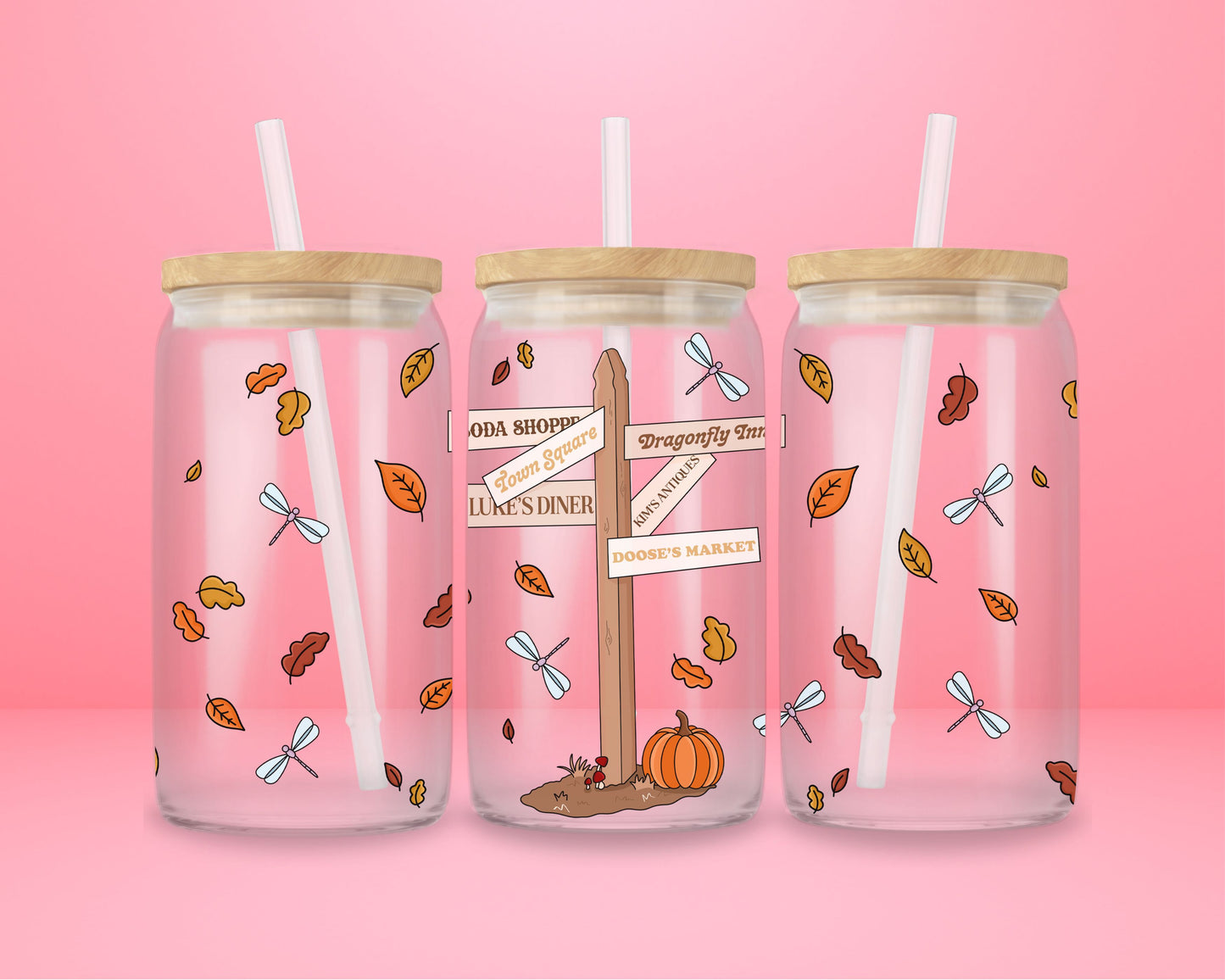 glass tumbler with wooden lid and straw featuring Stars Hollow signpost with “Luke’s Diner,” “Doose’s Market,” “Town Square,” and fall leaves.