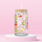 glass tumbler with jars of pickles, cherries, croissants, bows, and “Girl Dinner” snack bags, with bamboo lid and straw.