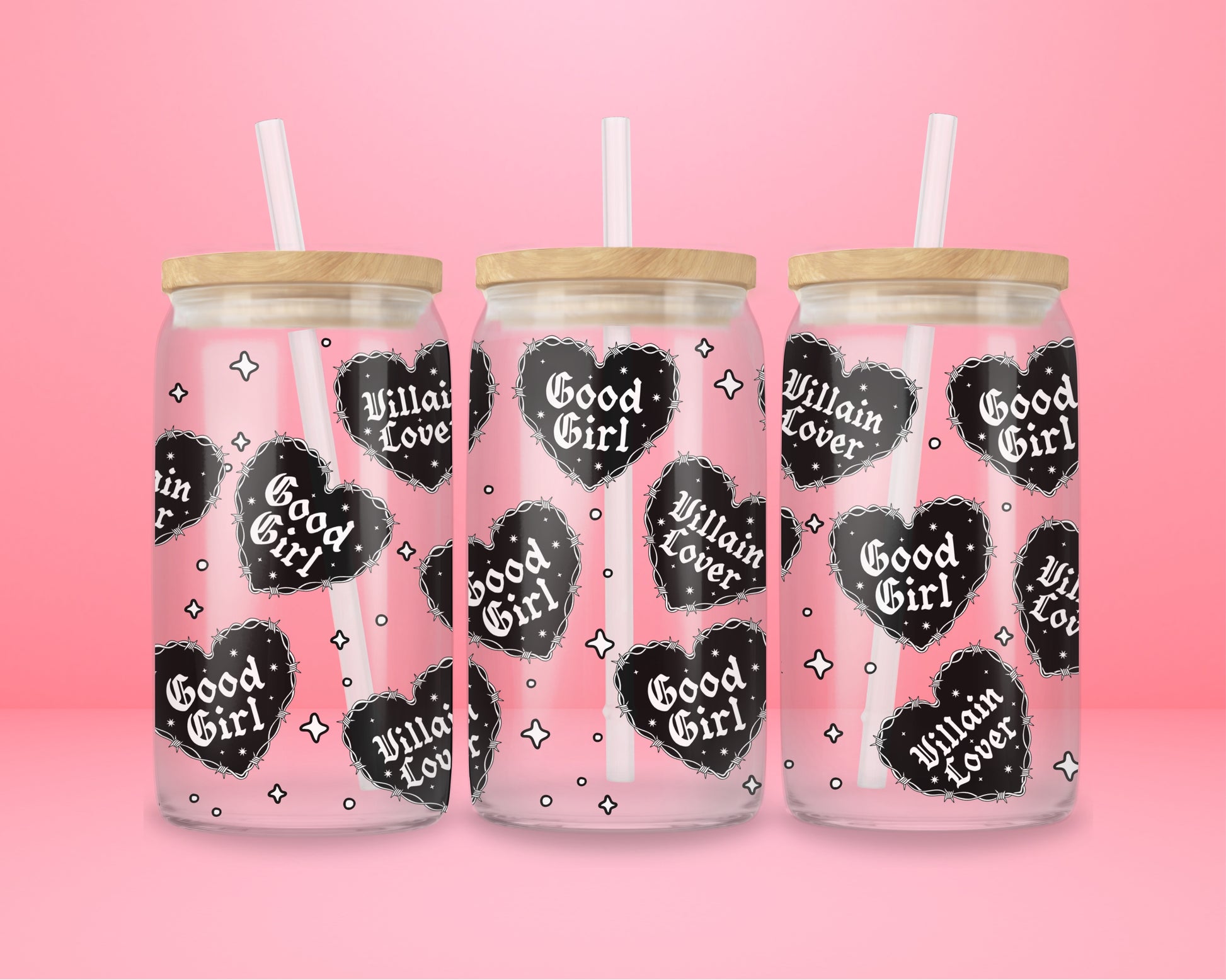 Glass can tumbler with bamboo lid and glass straw featuring black gothic heart designs with the words Good Girl and Villain Lover on a pink background.