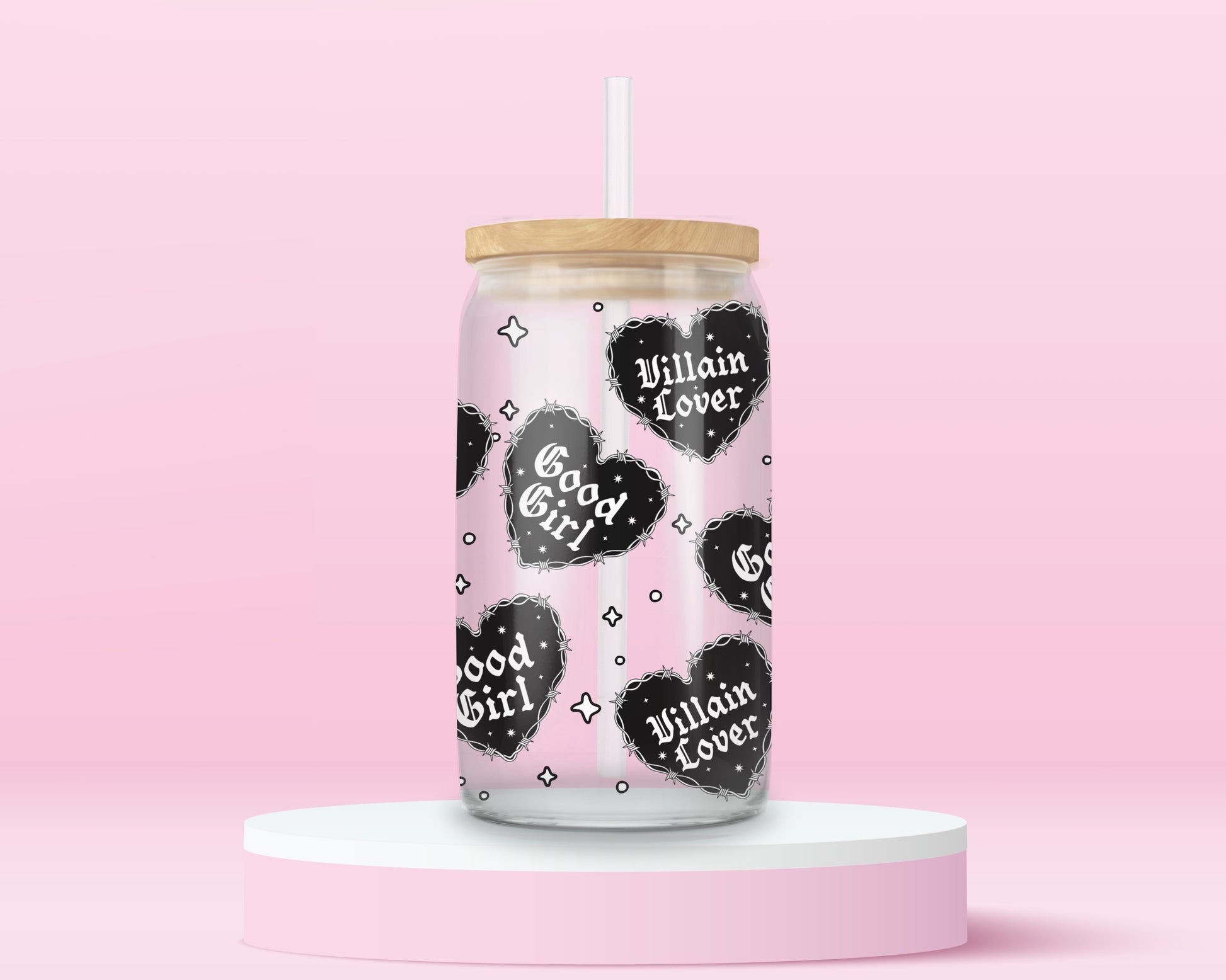 Glass can tumbler with bamboo lid and glass straw featuring black gothic heart designs with the words Good Girl and Villain Lover on a pink background.