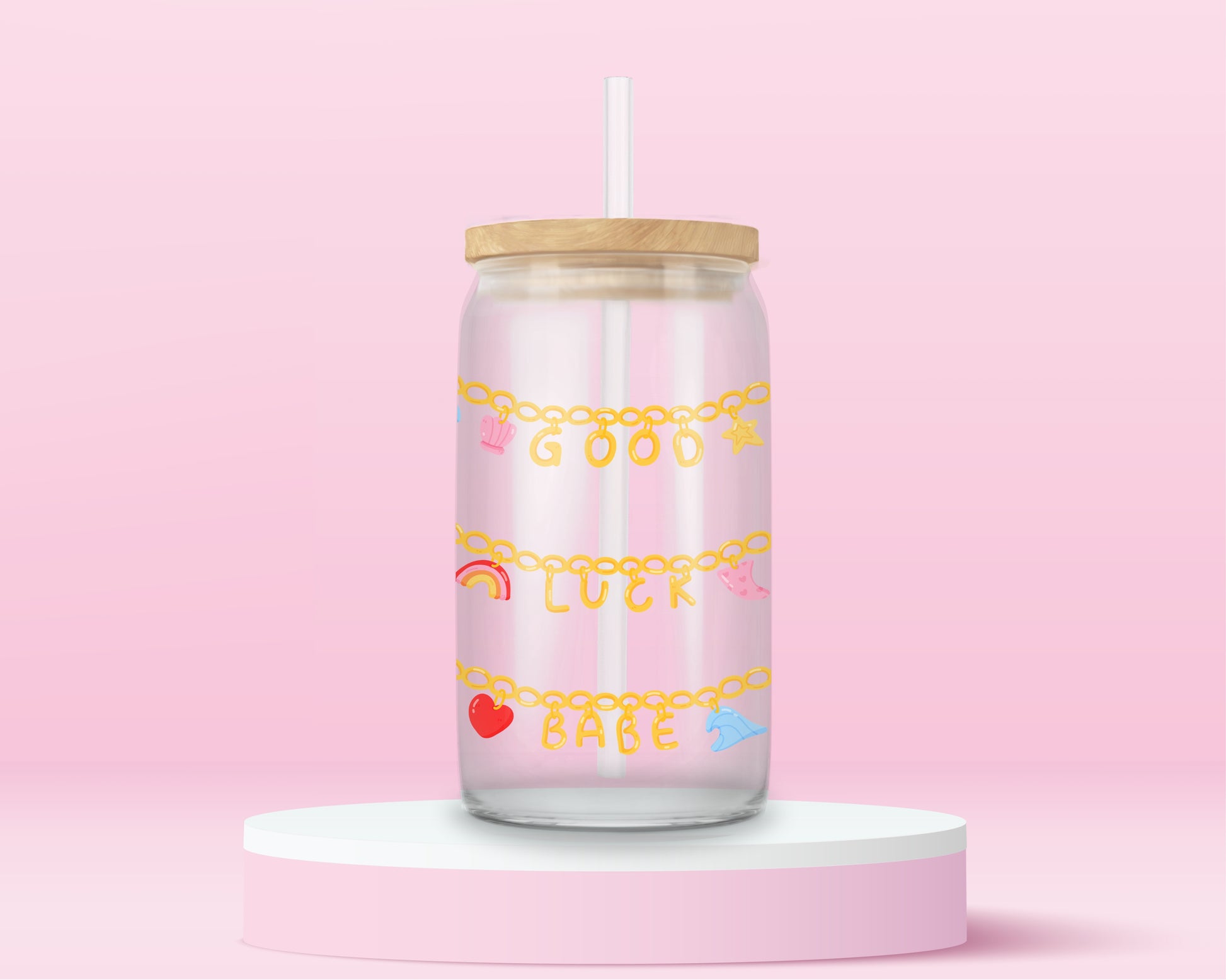 Glass tumbler with charm chains spelling good luck babe with colorful lucky symbols.