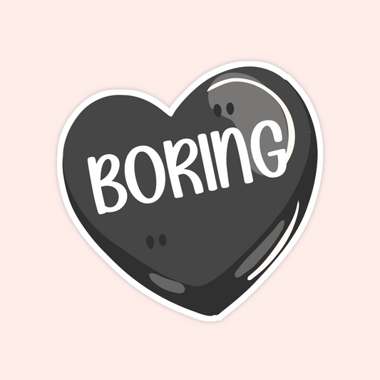 Black candy heart sticker that says “Boring,” inspired by Ilya’s line in Heated Rivalry by Rachel Reid.