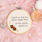 I don’t rise from the ashes I make them I’m the whole damn fire hand embroidered quote hoop with floral detail on pink background