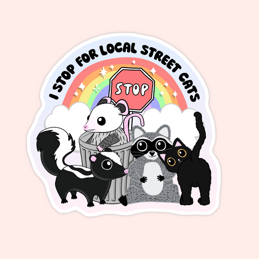 Sticker featuring a skunk, raccoon, opossum, and black cat under a rainbow with the words "I stop for local street cats."