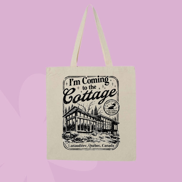 Canvas tote bag featuring vintage cottage illustration with the phrase I'm coming to the cottage inspired by Heated Rivalry.