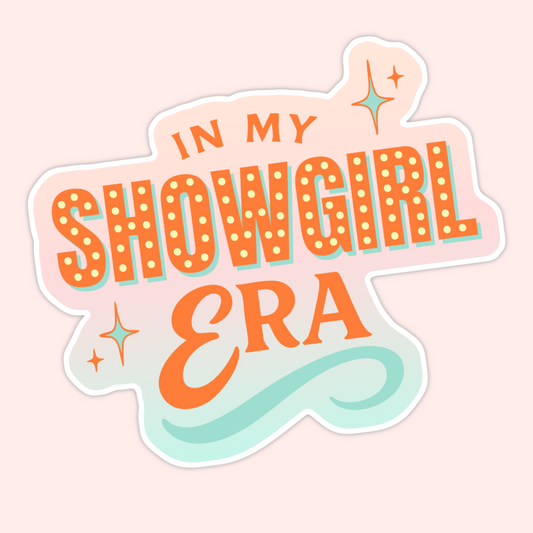 Retro-inspired sticker with bold orange lettering reading “In My Showgirl Era” with sparkles and a soft pastel background.