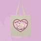 Beige canvas tote bag featuring a sleepy kitten inside a pink heart with text that says Sorry! I can’t go, I’m an indoor cat.