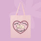 Pink canvas tote bag featuring a sleepy kitten inside a pink heart with text that says Sorry! I can’t go, I’m an indoor cat.