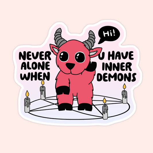Sticker of a cartoon demon goat waving inside a pentagram of candles with the words “Never alone when you have inner demons.”