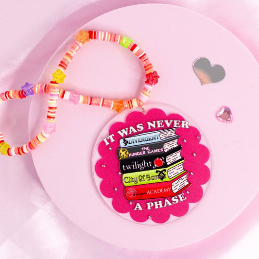 “Book-themed car charm featuring Divergent, Twilight, and more – nostalgic design for YA fiction lovers.”