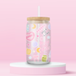 Pink girly glass can tumbler with books, croissants, bows, hearts, stars, and just a girl themed icons.