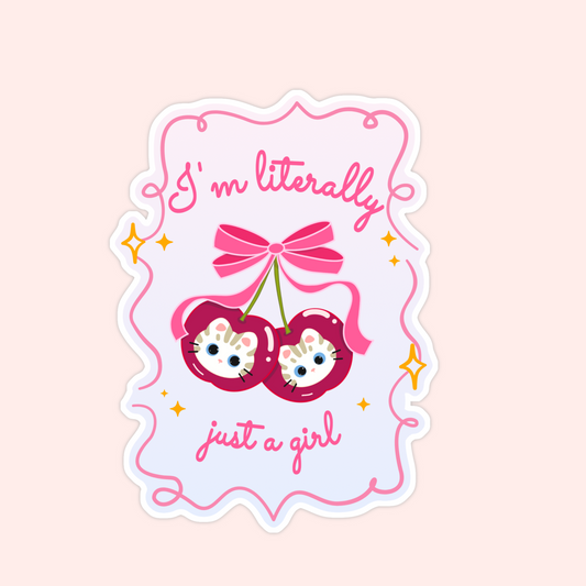 Sticker with two striped cat faces inside red cherries, tied with a pink bow, and the words “I’m literally just a girl.”
