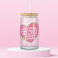 Pink heart glass can tumbler with the phrase “Just a Girl Who Needs Her Little Snacky Snacks” in sparkly retro lettering.