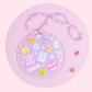 lavender aesthetic acrylic car charm with books, croissant, bows, stars, and pastel beaded hanger