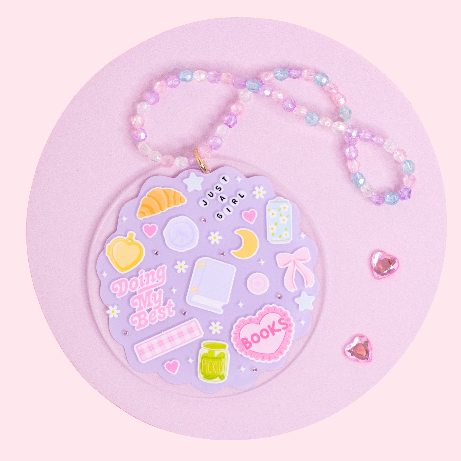 lavender aesthetic acrylic car charm with books, croissant, bows, stars, and pastel beaded hanger