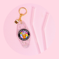 clear glitter motel style keychain with coffee cup graphic and “fueled by coffee and feminine rage” text, gold key ring and charm on pink background