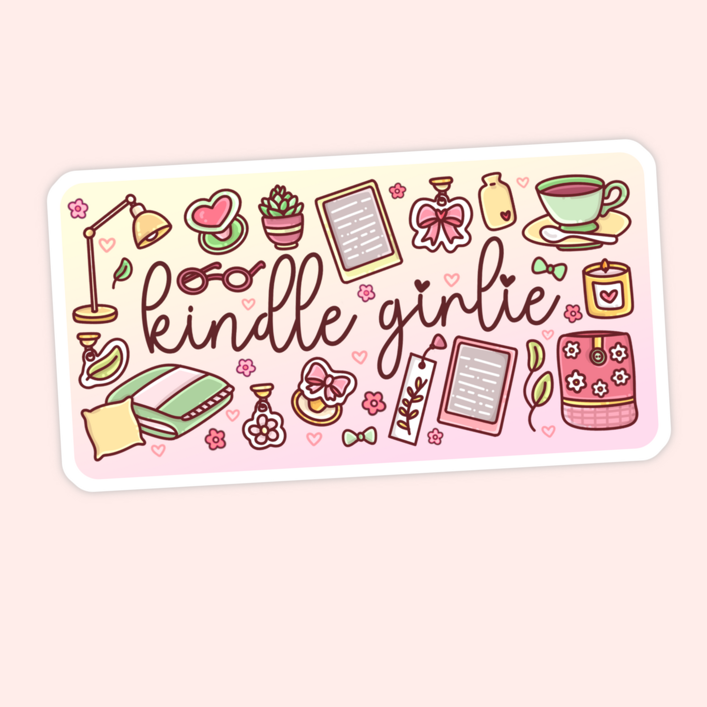 Cute Kindle girlie sticker with e-readers, cozy bed, pillow, lamp, tea cup, candle, bows, flowers, and bookish pink details.