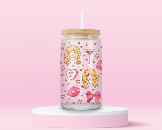 A girly pink glass cup featuring a blonde glam girl, pink bows, martinis, lipstick kisses, stars, and “kiss me” hearts — Sabrina Carpenter vibes all the way.