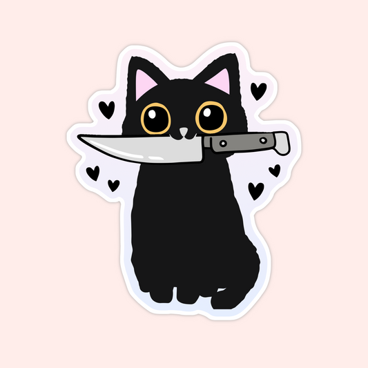 Sticker of a black cat with wide eyes holding a knife in its mouth, surrounded by hearts.