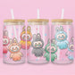 Glass tumbler with colorful Labubu characters in bunny suits (pink, orange, gray, green, blue) on a pastel pink background with stars.