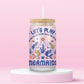 Glass can tumbler with bamboo lid and glass straw featuring retro-inspired mermaids, seashells, starfish, coral, fish, and the words Let’s Play Mermaids on a pink background.