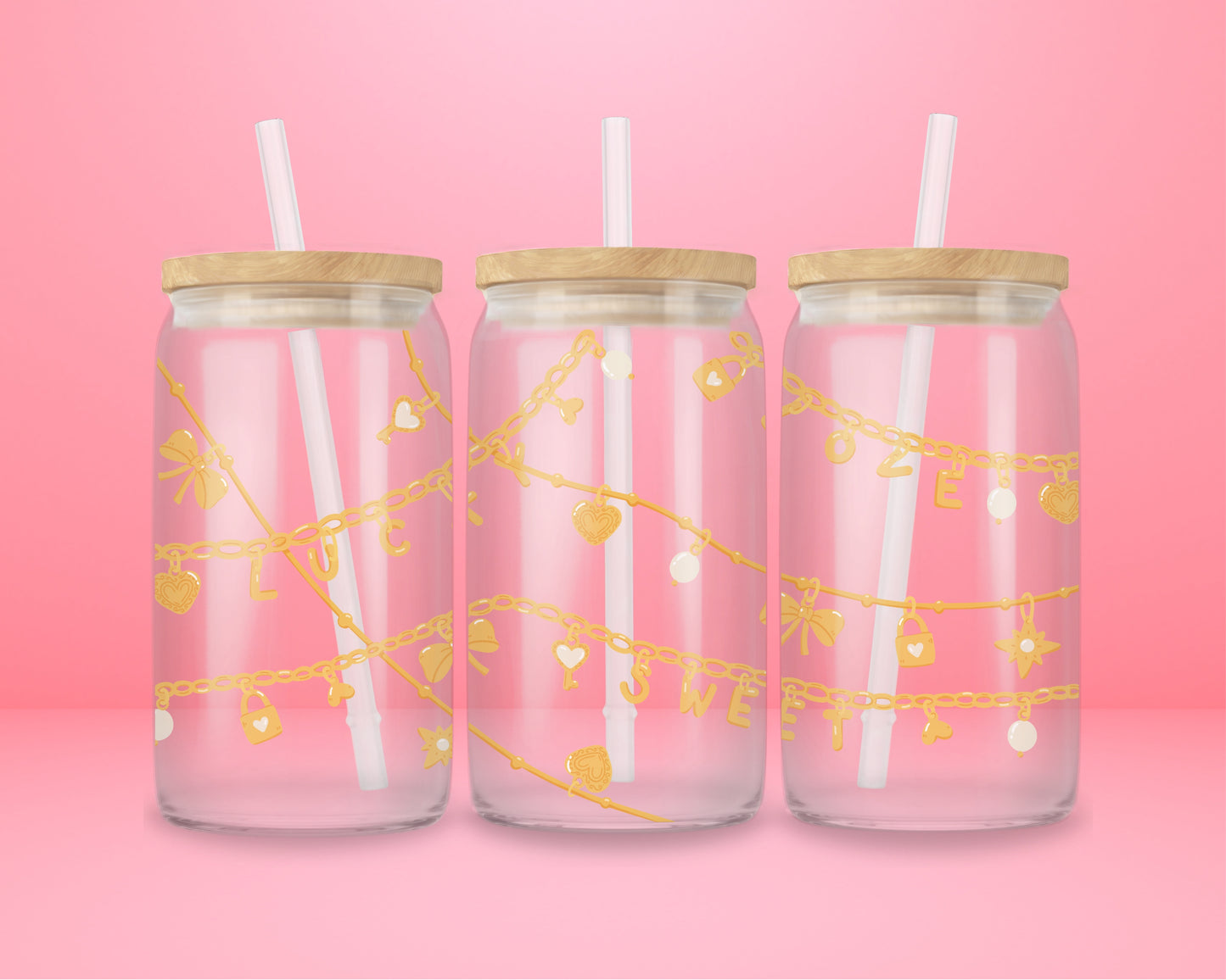 Pink glass can tumbler featuring gold charm chains with hearts, bows, stars, and the words lucky and sweet.