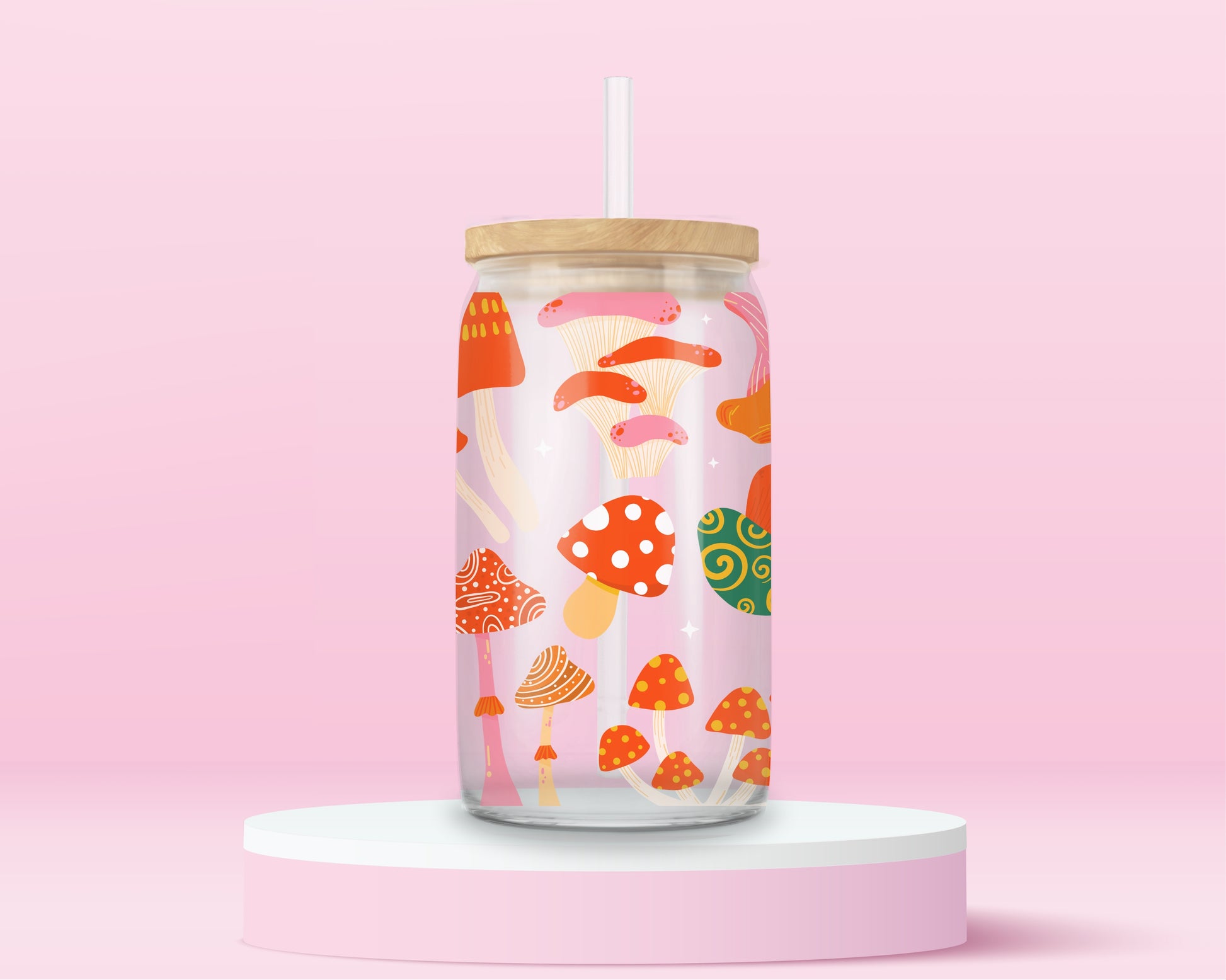 Glass tumbler with colorful whimsical mushrooms in a playful forest inspired pattern.