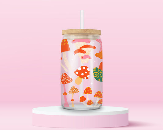 Glass tumbler with colorful whimsical mushrooms in a playful forest inspired pattern.