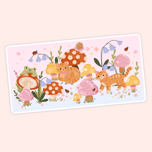 Cute cottagecore sticker with orange cats, mushrooms, flowers, ladybugs, and a little frog in a whimsical garden scene.